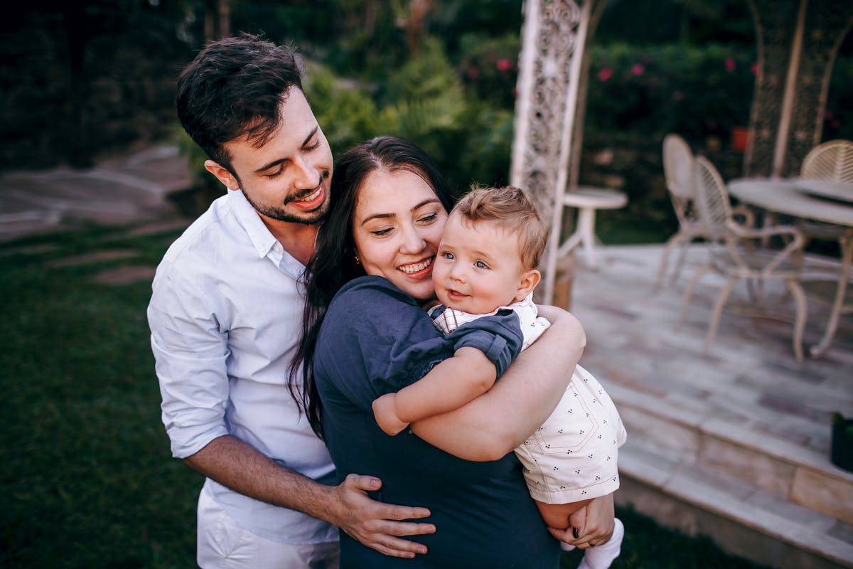 Young family embracing their child — life insurance protects what matters most